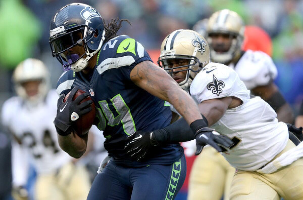 Seahawks running back Marshawn Lynch is tackled by Saints safety Roman Harper in an NFC divisional playoff game.