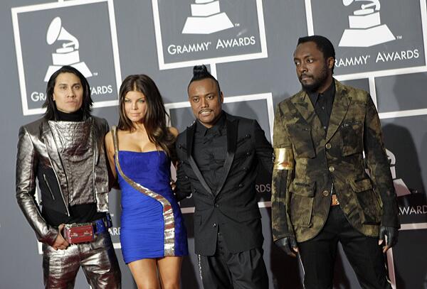 The Black Eyed Peas' Taboo, far left, wears a silver suit and will.i.am, far right, has an armband that pay tribute to Michael Jackson.