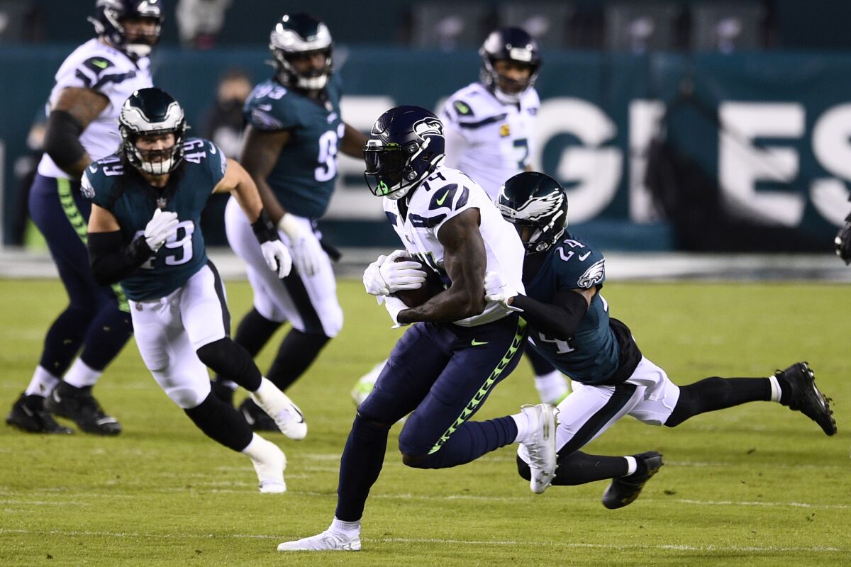 Seattle Seahawks' DK Metcalf, left, is tackled by Philadelphia Eagles' Darius Slay during the first half of an NFL football game, Monday, Nov. 30, 2020, in Philadelphia. (AP Photo/Derik Hamilton)