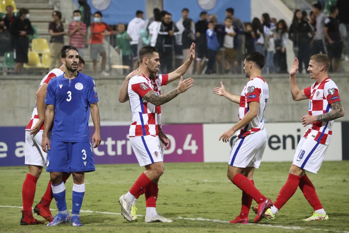 Croatia's Marko Livaja, second left, celebrates with his teammates the third goal of their team during the World Cup 2022 group H qualifying soccer match between Cyprus and Croatia at AEK arena Georgios Karapatakis stadium in Larnaca, Cyprus, Friday, Oct. 8, 2021. (AP Photo/Philippos Christou)