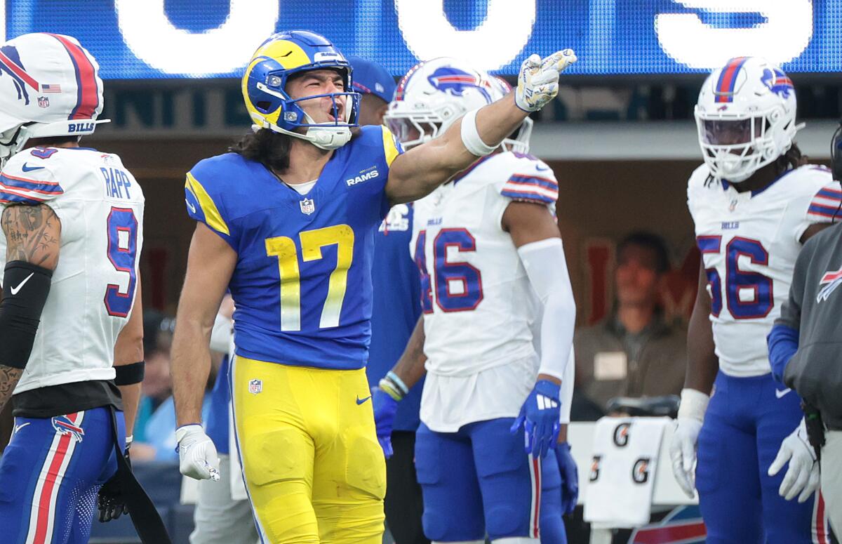 Rams receiver Puka Nacua signals first down by pointing his left arm forward.