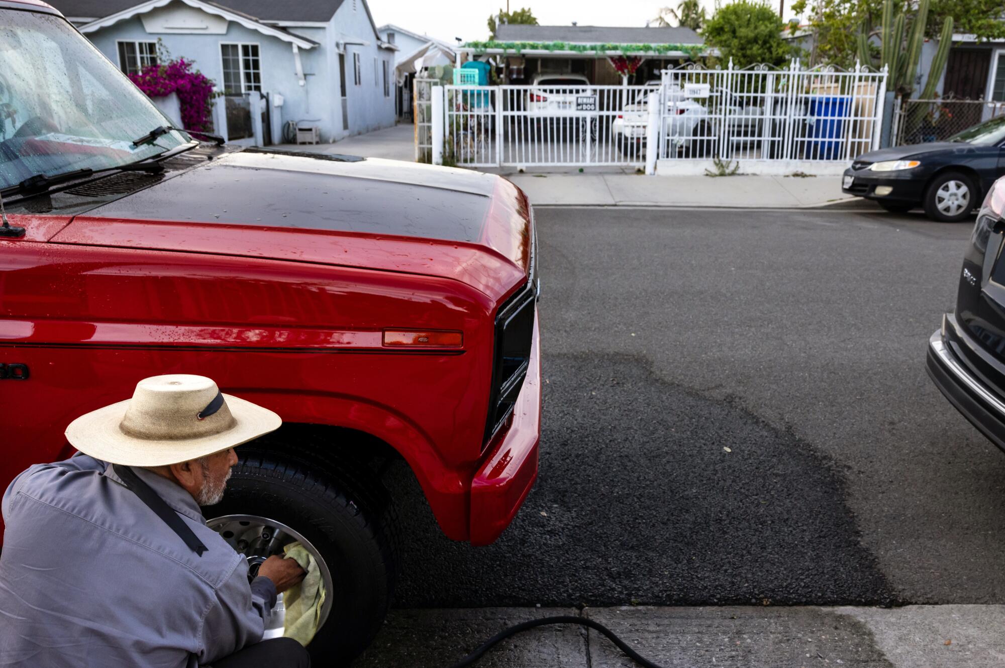 A dog guards a home in Artesia in the neighborhood where Father Cesar Galan lived and was shot.