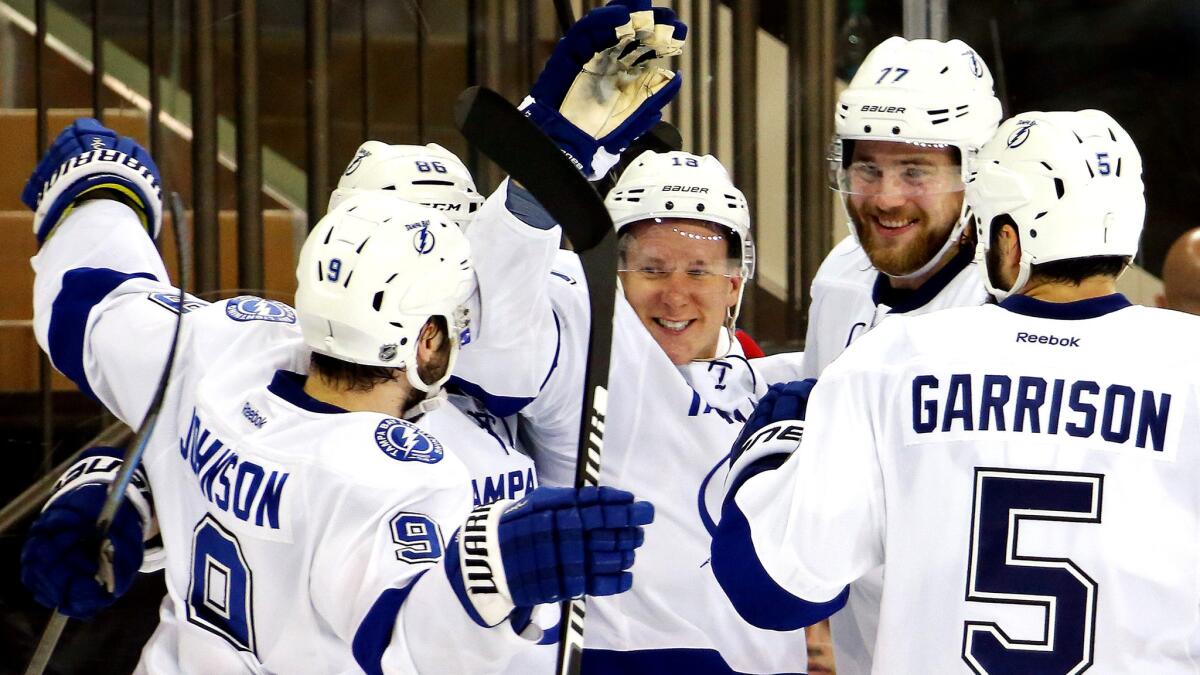 Lightning left wing Ondrej Palat (center) celebrates with teammates after scoring against the Rangers in the third period of Game 7 on Friday night in New York.