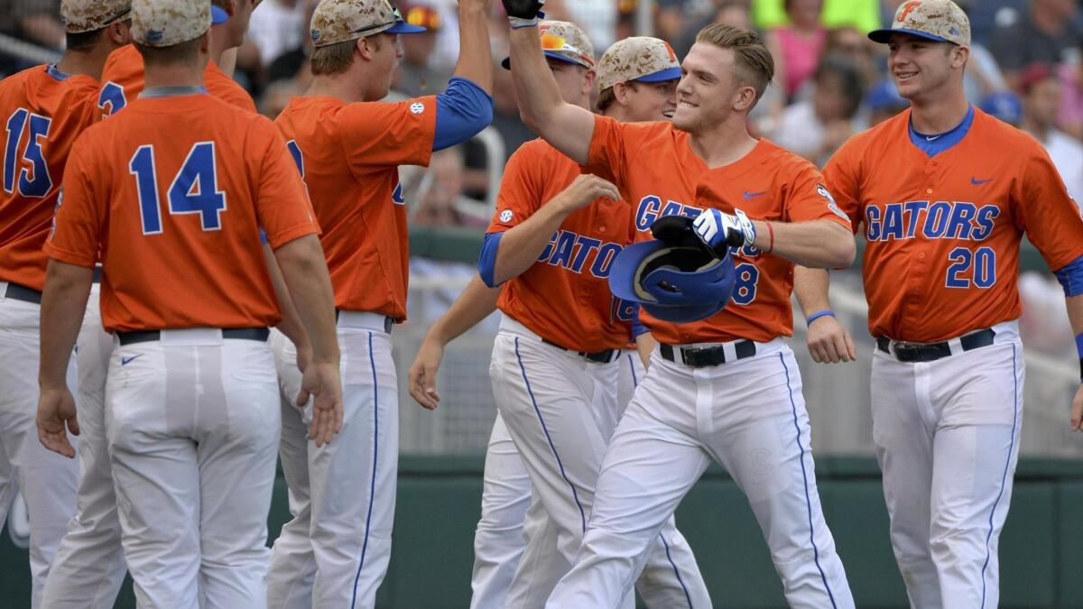 20 JUNE 2015: Florida's Harrison Bader swings during the College World  Series game between the Virginia