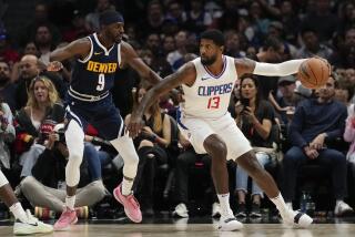 Denver Nuggets guard Justin Holiday (9) defends against Los Angeles Clippers forward Paul George (13) during the first half of a preseason NBA basketball game in Los Angeles, Tuesday, Oct. 17, 2023. (AP Photo/Ashley Landis)