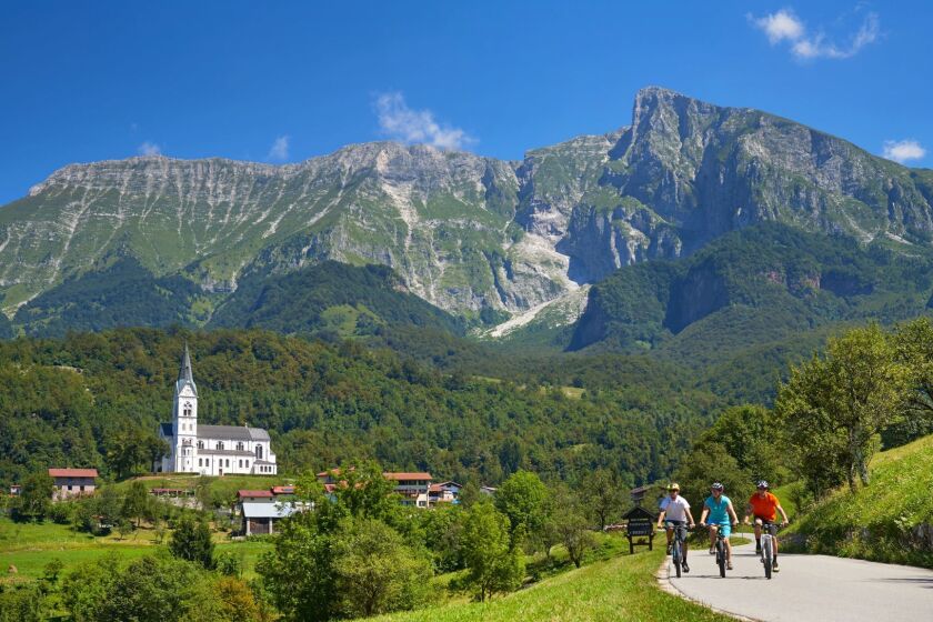 Bicyclists ridding e-bikes in Soca Valley, Slovenia. Bicycle Adventures e-bike tour.