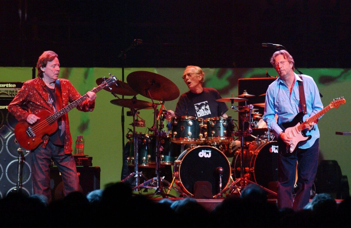Bassist Jack Bruce, left, drummer Ginger Baker and Eric Clapton of Cream perform at their first 2005 reunion concert at London's Royal Albert Hall in 2005. Baker, who is now 80, is critically ill and has been hospitalized, according to his family.