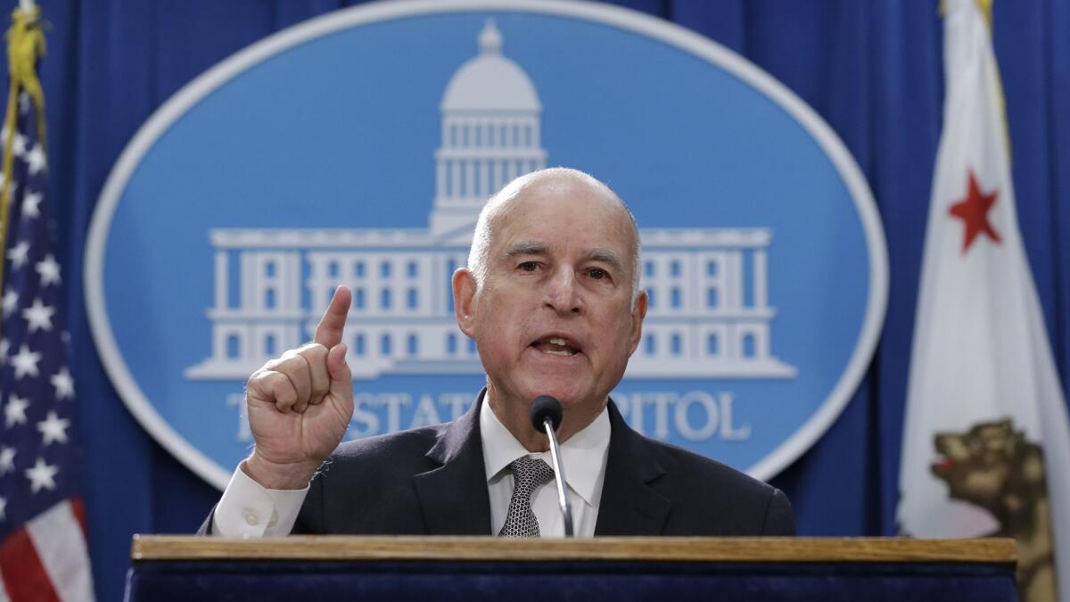Gov. Jerry Brown, shown at a May 1 news conference, unveiled a revised state budget plan on Friday that again seeks to avoid spending an income tax windfall on ongoing programs.