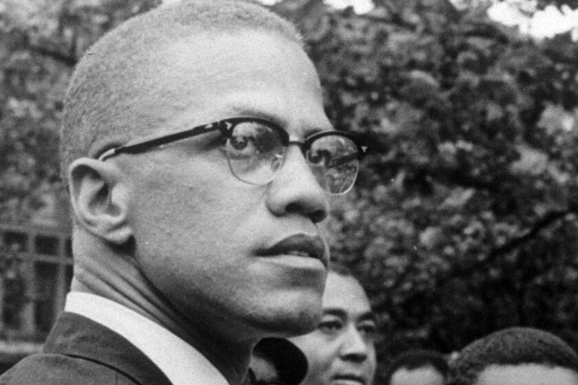 FILE - In this 1963 file photo, Malcolm X attends a rally at Lennox Avenue and 115th Street in the Harlem neighborhood of New York. The Nebraska Legislature on Thursday, March 28, 2024 passed a bill to recognize the civil rights icon every May 19, the day Malcolm X was born Malcolm Little in Omaha, Nebraska, in 1925. The amendment recognizes May 19 as El-Hajj Malik El-Shabazz, Malcolm X Day, to allow Nebraska schools to hold exercises to recognize the civil rights leader. (AP Photo/Robert Haggins, File)
