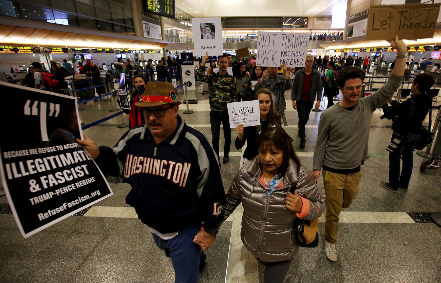 Protesters march through Tom Bradley International Terminal to voice opposition to President Trump's refugee policy.