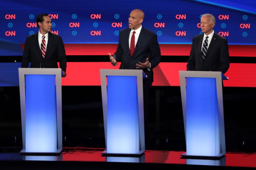 DETROIT, MICHIGAN - JULY 31: Democratic presidential candidate Sen. Cory Booker (D-NJ) speaks while former housing secretary Julian Castro (L) and former Vice President Joe Biden listen during the Democratic Presidential Debate at the Fox Theatre July 31, 2019 in Detroit, Michigan. 20 Democratic presidential candidates were split into two groups of 10 to take part in the debate sponsored by CNN held over two nights at Detroits Fox Theatre. (Photo by Scott Olson/Getty Images) ** OUTS - ELSENT, FPG, CM - OUTS * NM, PH, VA if sourced by CT, LA or MoD **