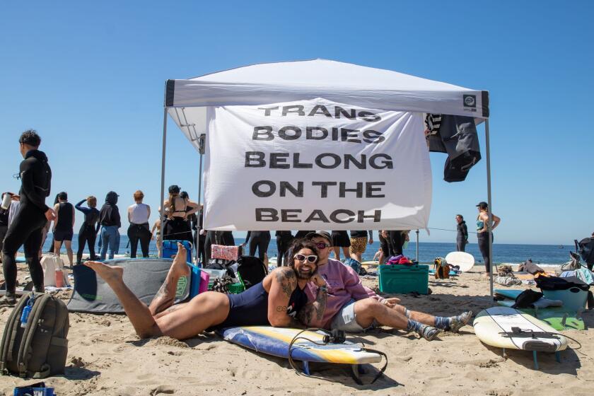 J Cagandahan (left) and Mud Howard (right) attend the "Trans Surf Boogie and Beach Day" event on April 1, 2023 at Will Rogers State Beach.