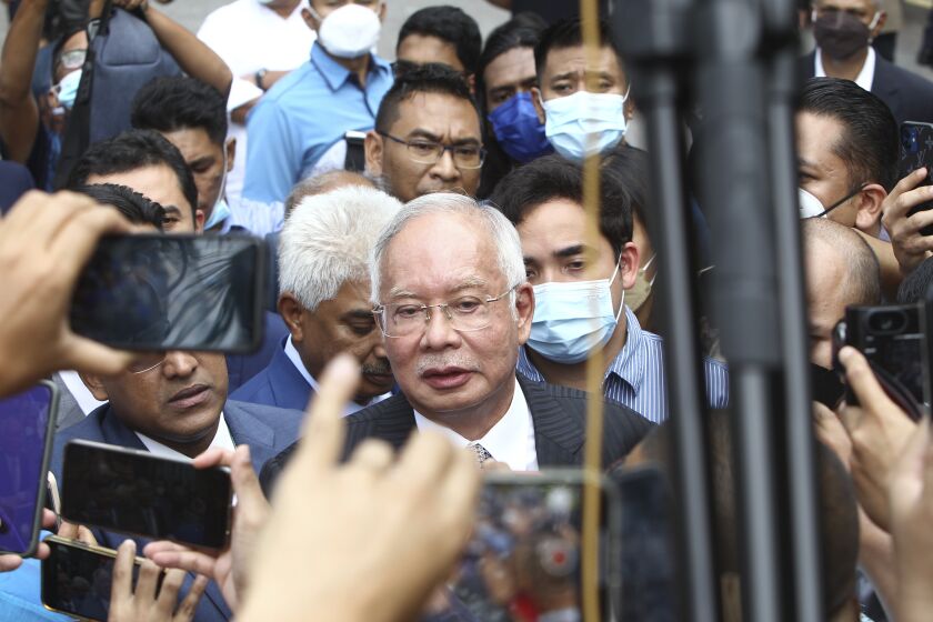 Former Malaysian Prime Minister Najib Razak, center, speaks to supporters outside at Court of Appeal in Putrajaya, Malaysia Tuesday, Aug. 23, 2022. Malaysia’s top court has upheld Najib’s conviction and 12-year jail sentence in a graft case linked to the looting of the 1MDB state fund. Najib’s loss in his final appeal means he will have to begin serving his sentence immediately, becoming the first former prime minister to be jailed. (AP Photo)