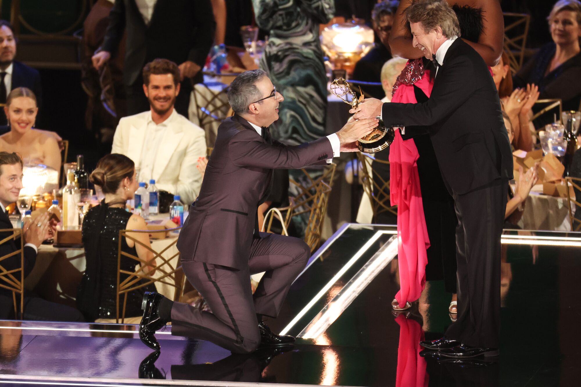 John Olivers accept award from Martin Short