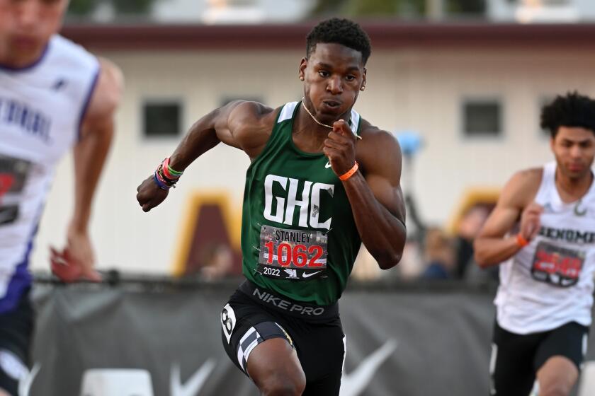 ARCADIA, CA - APRIL 9, 2022: Dijon Stanley of Granada Hills Charter, center, finished second in the boys' 400 meter dash.
