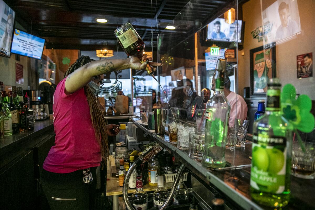Bartender Christina Flintland serves drinks in Covina on Sunday.