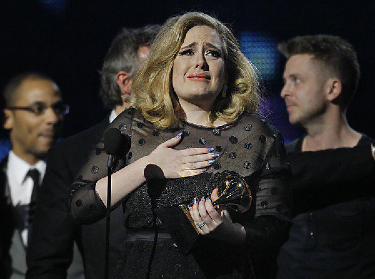 An emotional Adele reacts while accepting her sixth Grammy of the night during last year's Grammy Awards.