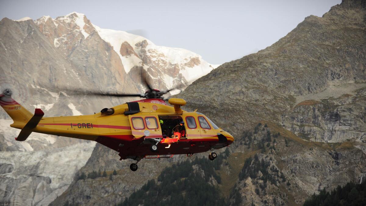 A rescue helicopter heads for passengers stranded in the Mont Blanc cable cars near Courmayeur, Italy, on Sept. 9.