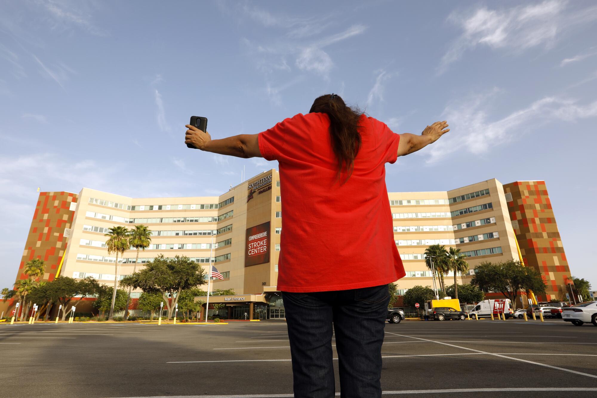 A man prays for coronavirus patients in the parking lot of South Texas Health System McAllen.