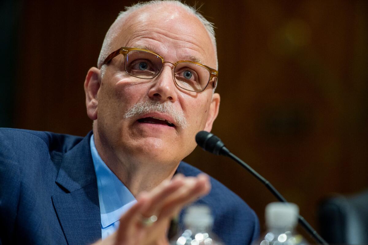 Chris Magnus speaks into a microphone during his Senate confirmation hearing in 2021