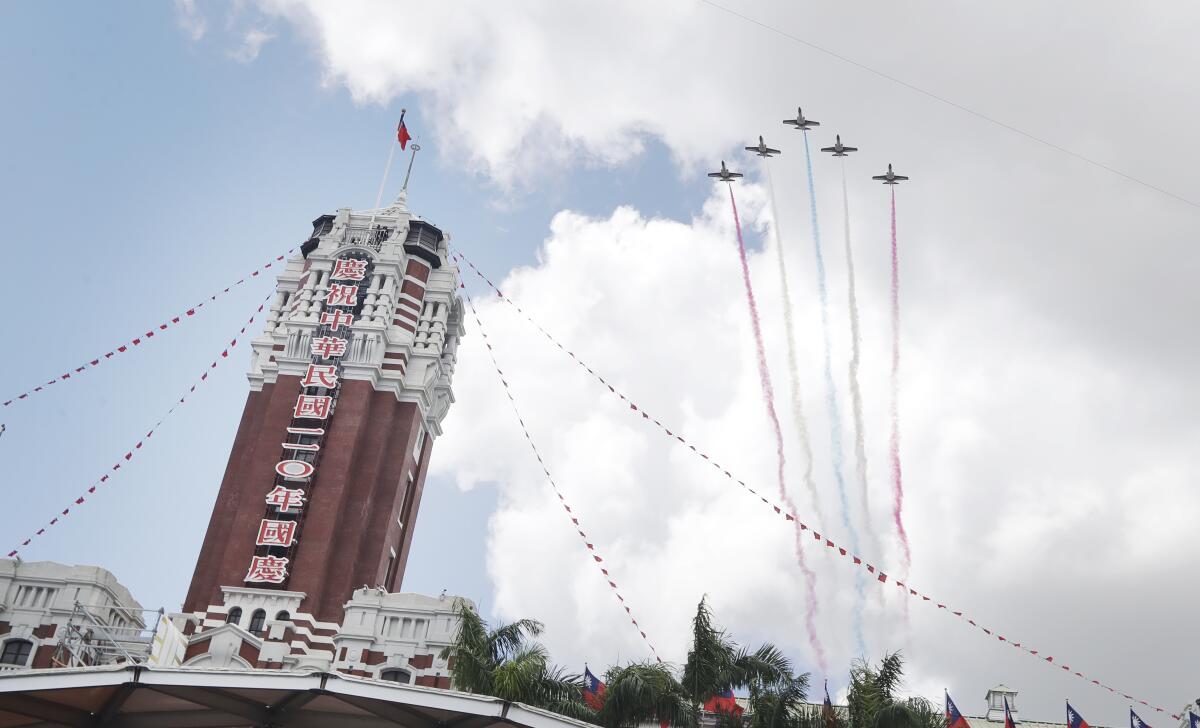 Thunder Tiger Aerobatics Team fly over President Office during National Day celebrations in Taipei, Taiwan, Sunday, Oct. 10, 2021. (AP Photo/Chiang Ying-ying)