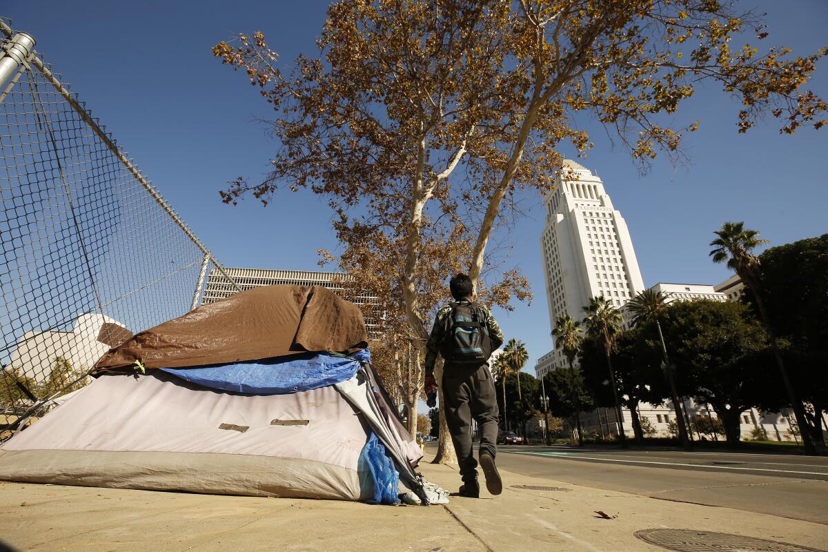 An encampment blocks the sidewalk on Spring Street near Los Angeles City Hall in 2021.