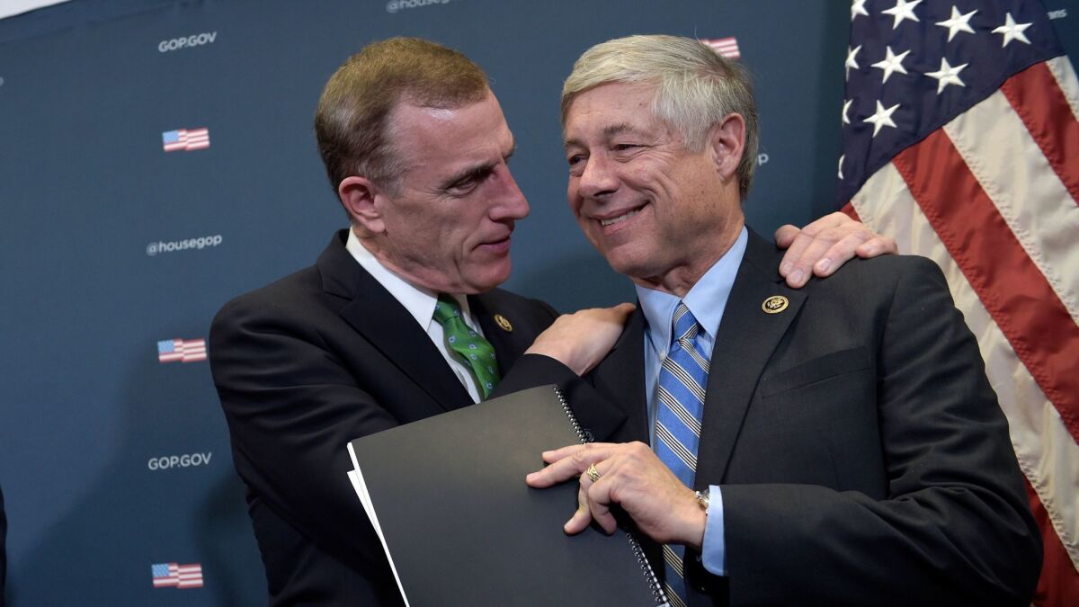 Rep. Tim Murphy (R-Pa.), left, embraces Rep. Fred Upton (R-Mich.), the sponsor of the 21st Century Cures Act.