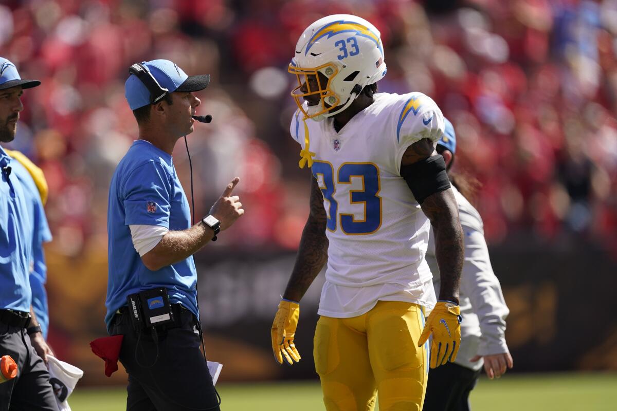 Chargers coach Brandon Staley talks with safety Derwin James as he comes off the field.
