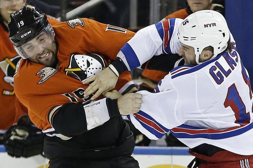 New York Rangers' Tanner Glass, right, and Anaheim Ducks' Patrick Maroon fight during the first period on Tuesday.