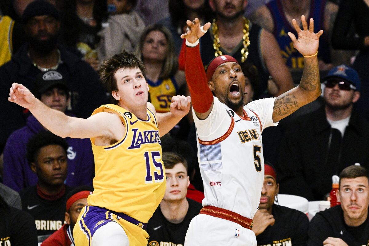 Lakers guard Austin Reaves fouls Denver Nuggets guard Kentavious Caldwell-Pope on a three-point shot.