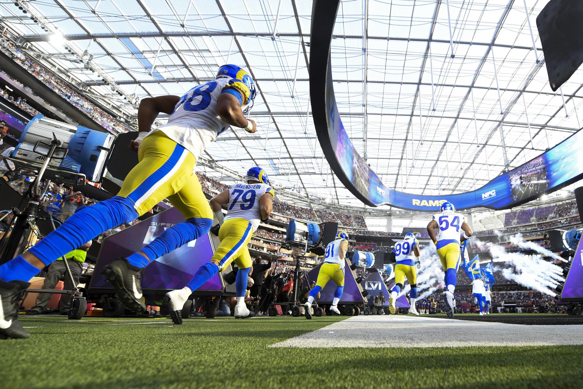  Rams players run onto the field before the start of the Super Bowl game.the field  