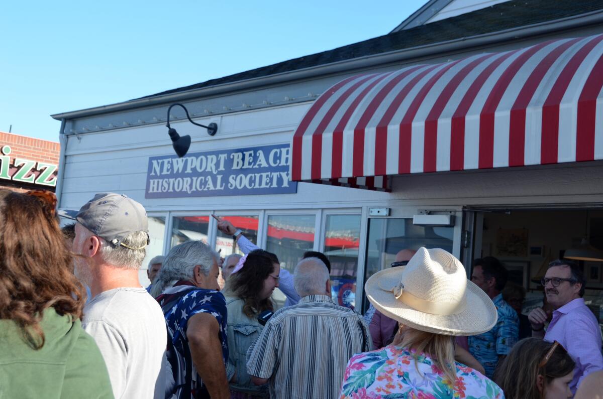 About 50 people gathered for the opening of the Newport Beach Historical Society's museum at the Balboa Fun Zone Friday.