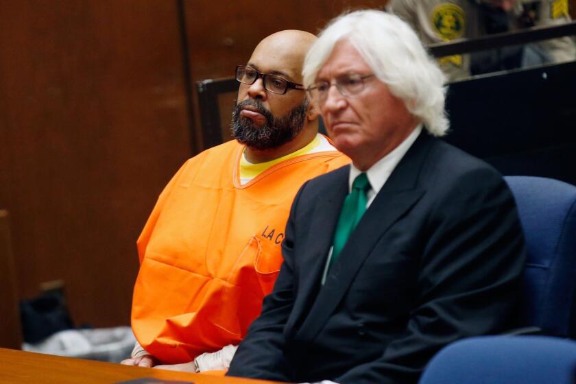 Marion "Suge" Knight, left, appears with his attorney, Thomas A. Mesereau Jr., during a court hearing in his murder case.