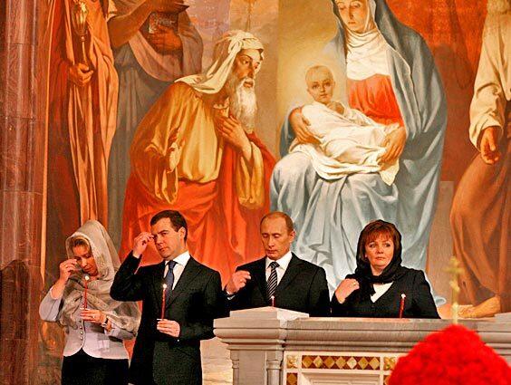 Russian President Vladimir V. Putin with his wife, Lyudmila, and Russian President-elect Dmitry Medvedev and wife Svetlana attend the Orthodox Easter service in Christ the Savior's Cathedral in Moscow.
