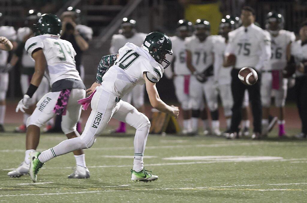 Costa Mesa High quarterback Ben Swanson runs after a fumble against Costa Mesa.