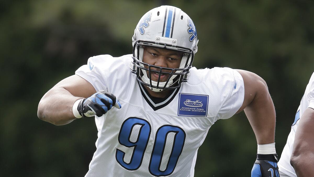 Detroit Lions defensive tackle Ndamukong Suh takes part in a training camp drill in July.