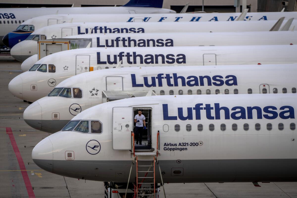 Lufthansa airplanes are parked at the airport.