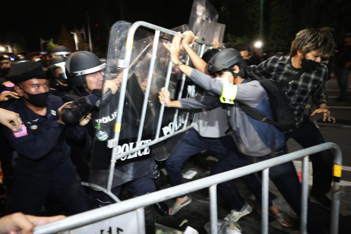 Pro-democracy protesters clash with Thai police officers in Bangkok on Thursday.