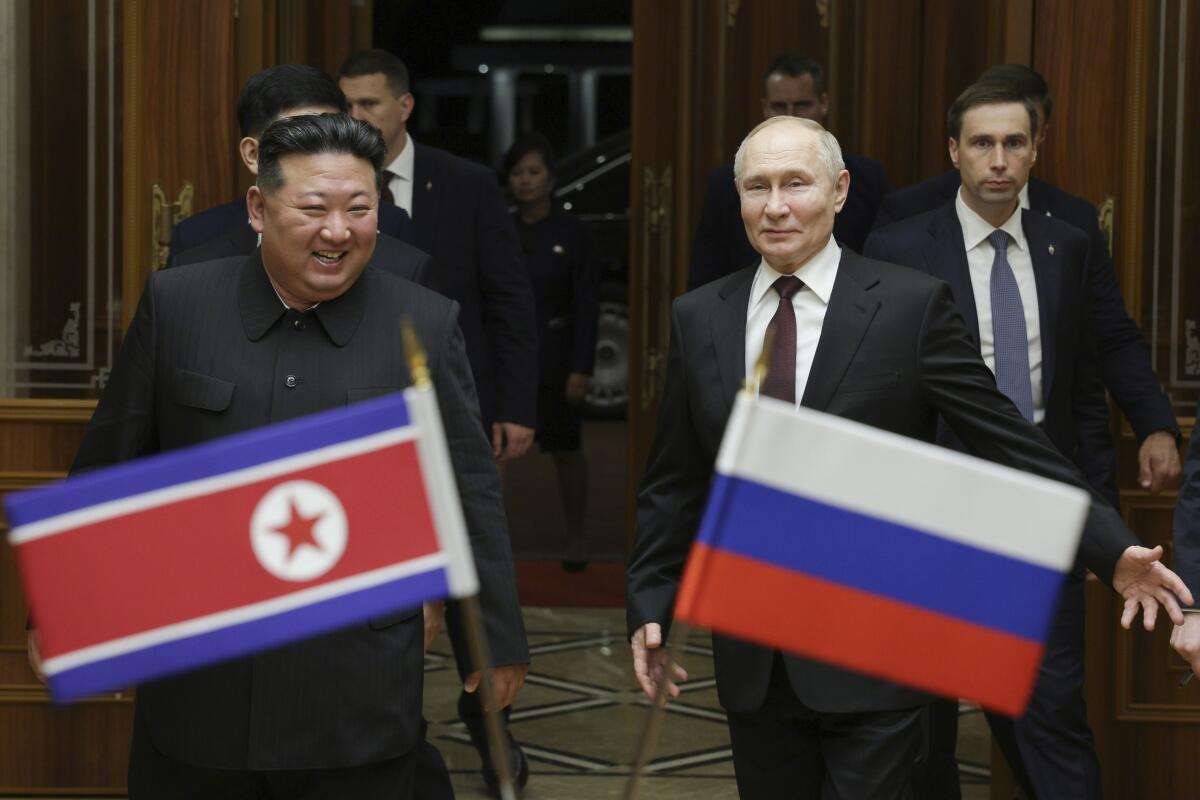 Russian President Vladimir Putin, right, and North Korea's leader Kim Jong Un at Pyongyang Sunan International Airport.
