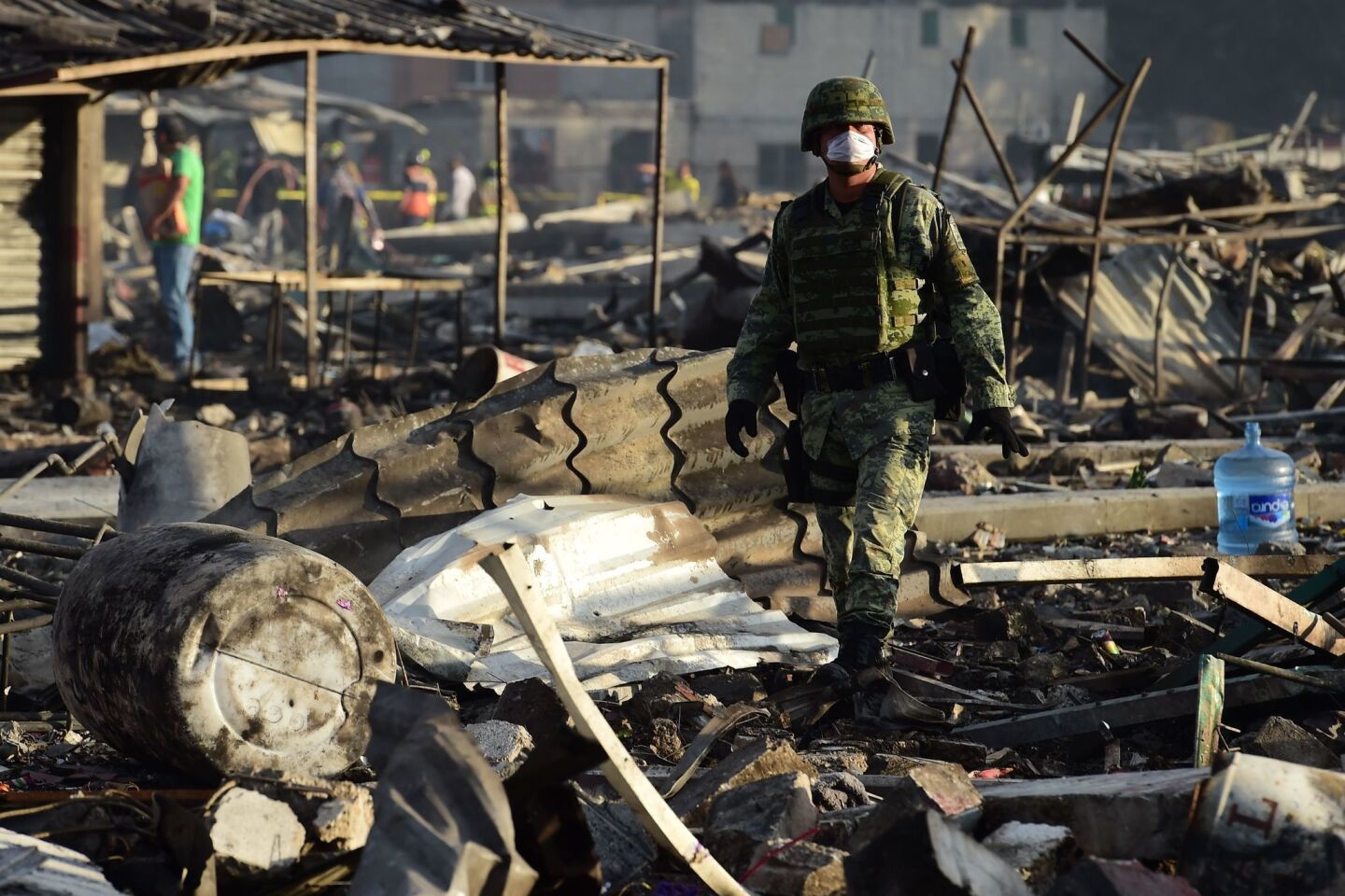 Soldiers search amid the debris left by deadly blasts at a fireworks market north of Mexico City.