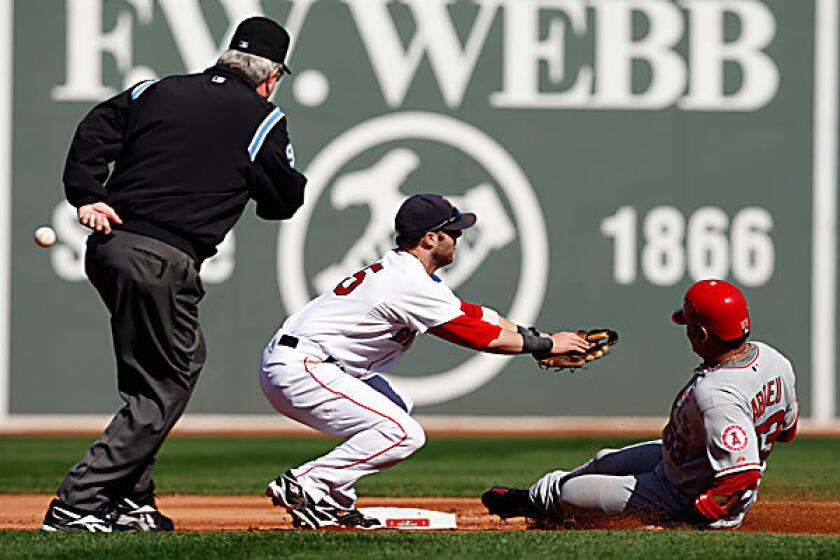 Angels right fielder Bobby Abreu slides safely into second base as Red Sox second baseman Dustin Pedroia tries to field the throw Sunday afternoon in Game 3 of the American League division series at Fenway Park.
