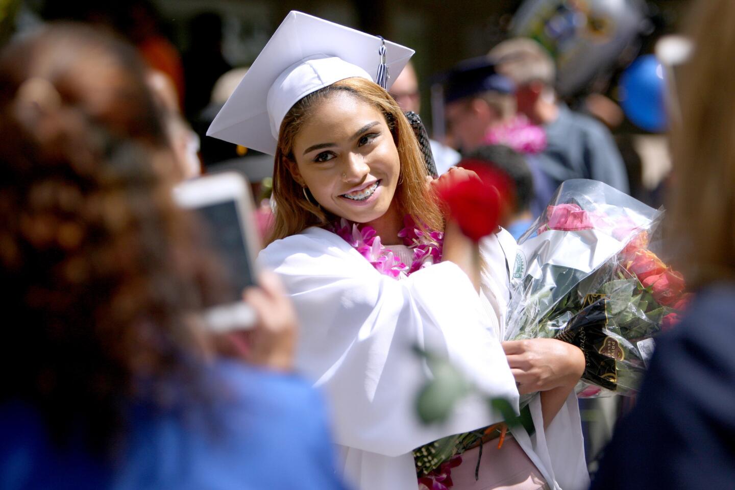 Family members take Daily High School graduate Mayah Pearson's photo after commencement exercises for DHS, Re-Connected Glendale and Verdugo Academy at First United Methodist Church in Glendale on Wednesday, June 1, 2016. About 70 students participated in the Glendale Unified School District ceremony.