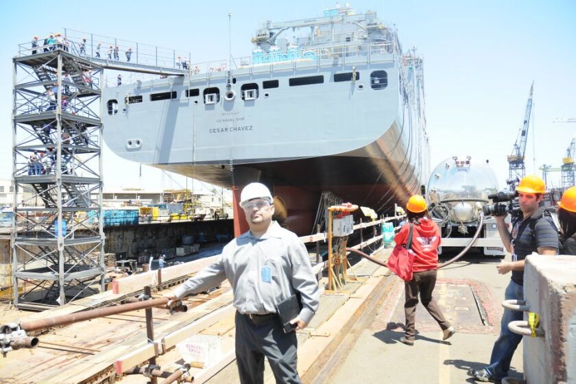 Pedro Anaya poses near the USNS Cesar Chavez cargo ship.