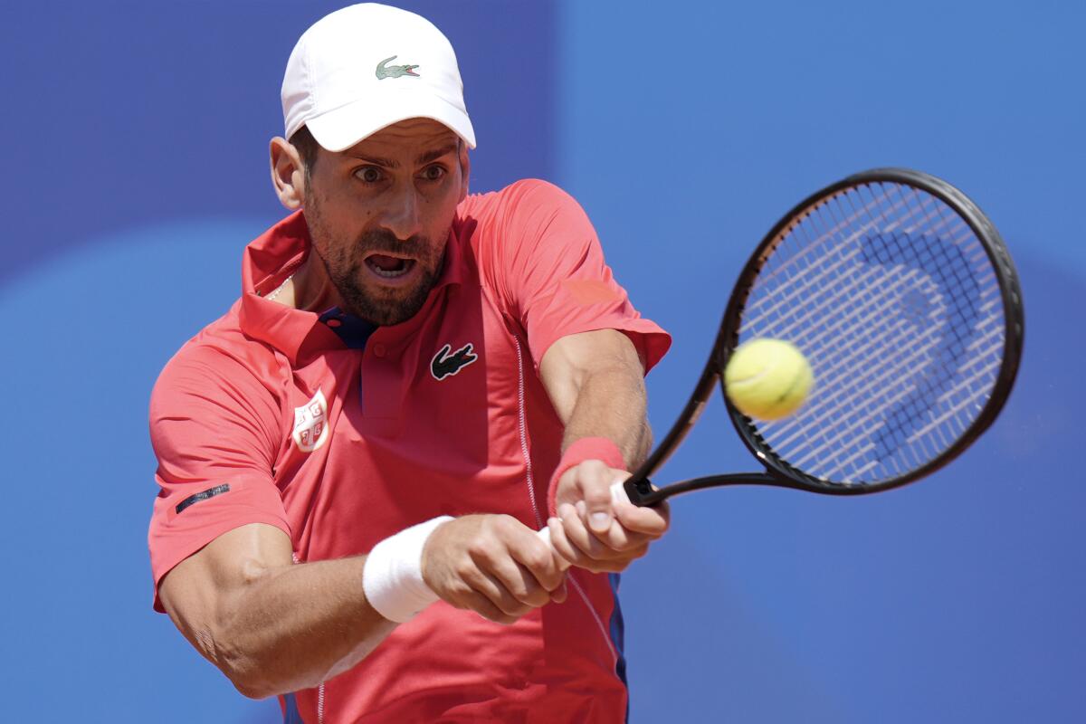 Novak Djokovic hits a return during his victory over Rafael Nadal at the Paris Olympics on Monday.