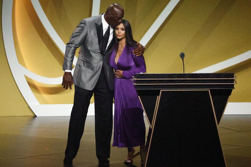 Hall of Famer Michael Jordan gives Vanessa Bryant a kiss on the head after her speech at the Hall of Fame induction.