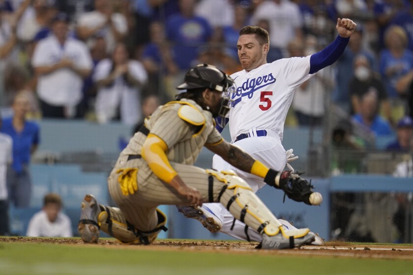 Freddie Freeman scores past Padres catcher Luis Campusano on Will Smith's third-inning double for the Dodgers.