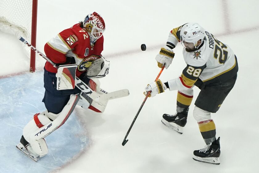 Florida Panthers goaltender Sergei Bobrovsky (72) defends the goal against Vegas Golden Knights left wing William Carrier (28) during the third period of Game 3 of the NHL hockey Stanley Cup Finals, Friday, June 9, 2023, in Sunrise, Fla. (AP Photo/Lynne Sladky)