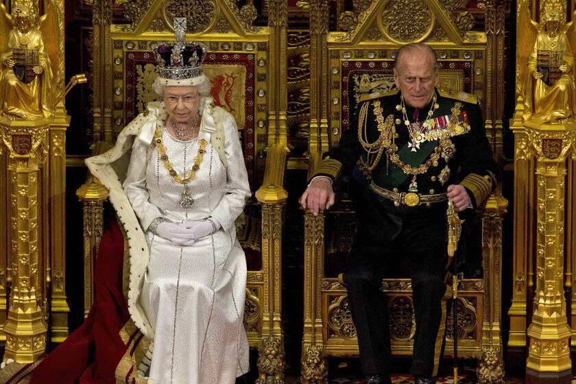 FILE - In this Wednesday, May 9, 2012 file photo, Britain's Queen Elizabeth II sits next to Prince Philip in the House of Lords as she waits to read the Queen's Speech to lawmakers in London. Buckingham Palace says Prince Philip, husband of Queen Elizabeth II, has died aged 99. (AP Photo/Alastair Grant, File)