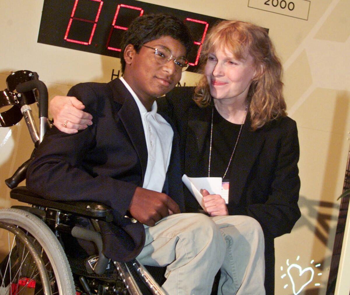 Actress Mia Farrow poses with her son Thaddeus at a global summit on polio eradication at United Nations headquarters on Sept. 27, 2000.