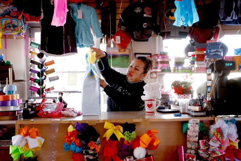 Susan Flores, 45, works in her flower shop in Cudahy.